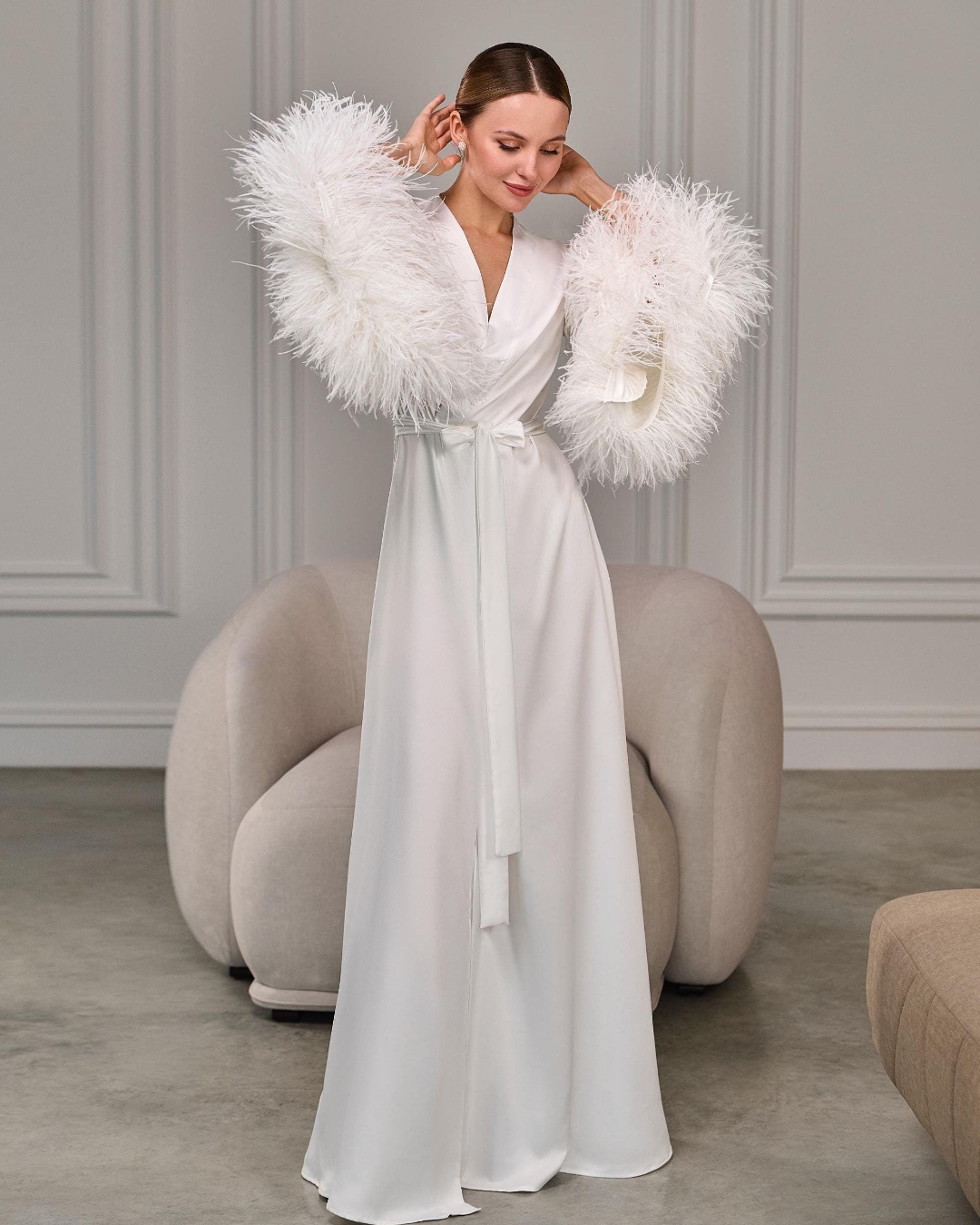 Ivory satin bridal robe with dramatic ostrich feather sleeves, front view