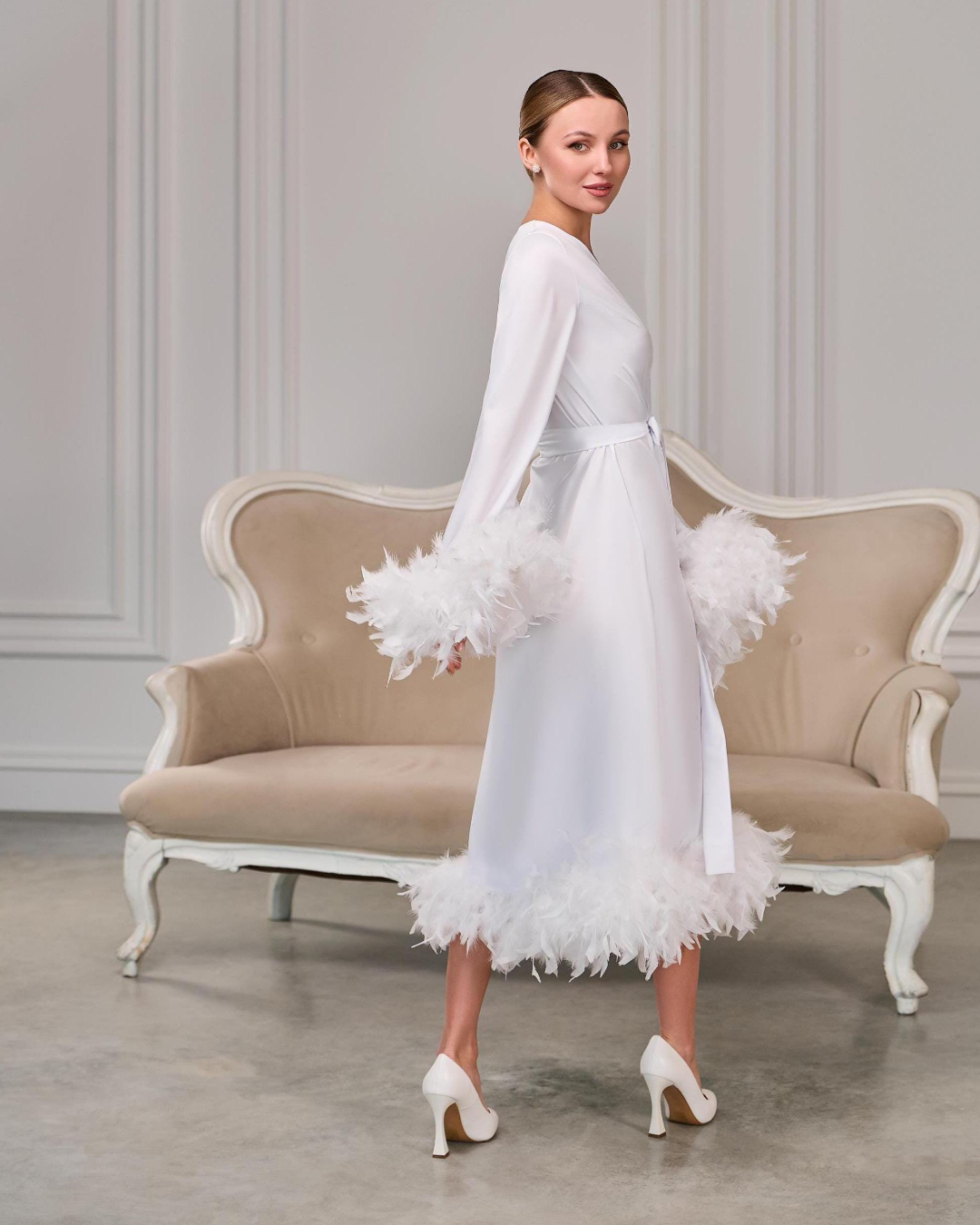 a woman in a white robe and high heels