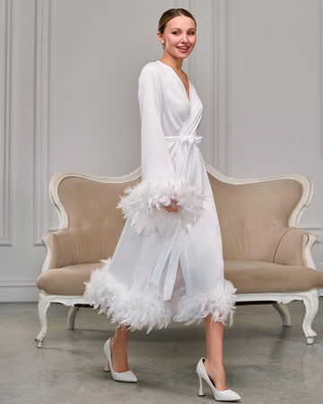a woman in a white robe and high heels