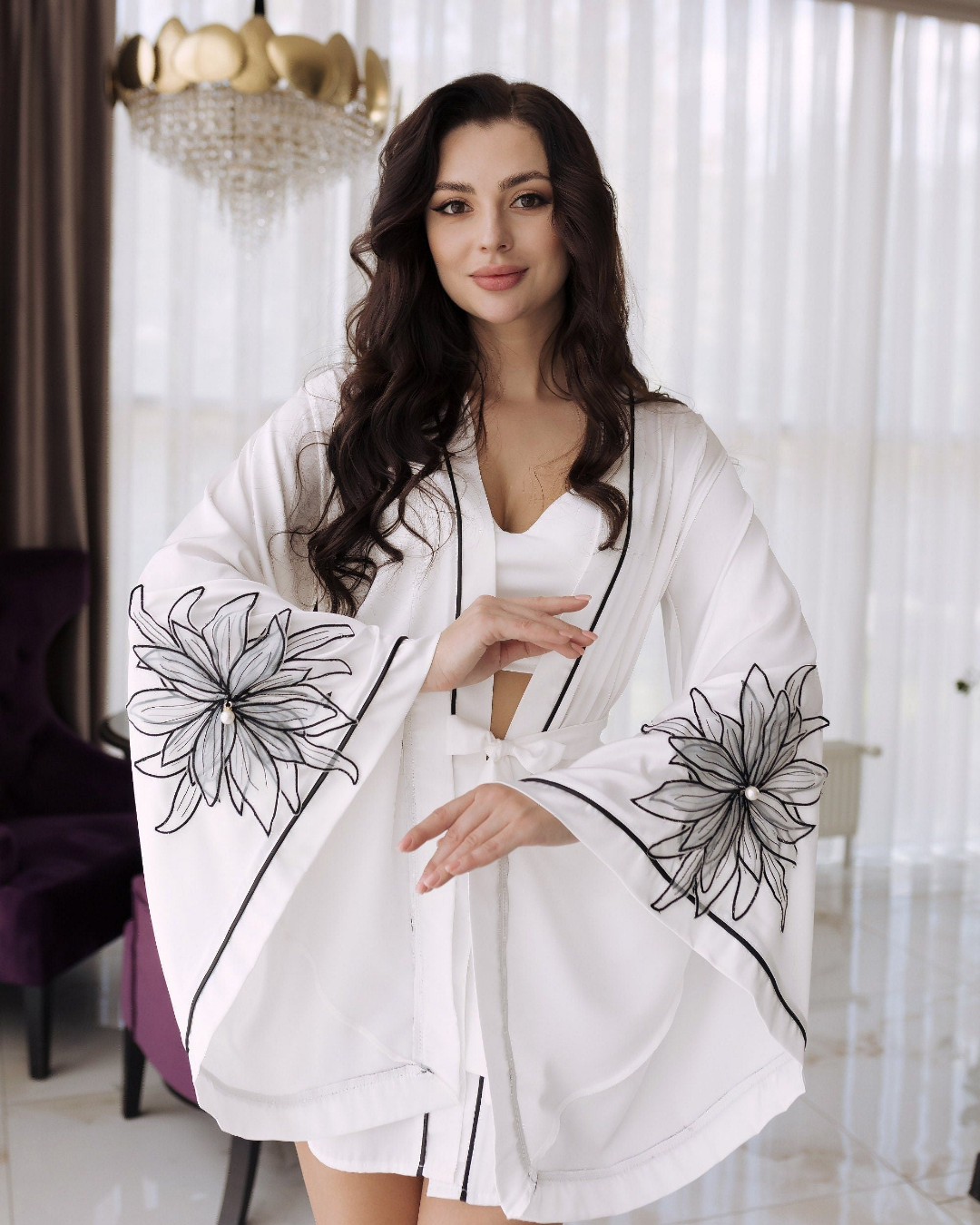 a woman in a white robe posing for a picture