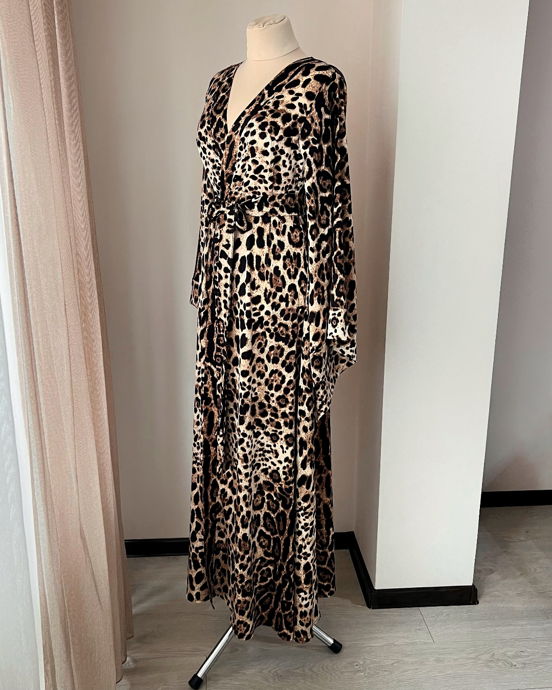 Long satin robe on a mannequin in a room