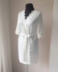 a white robe on a mannequin on a stand