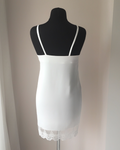 a white dress on a mannequin in a room