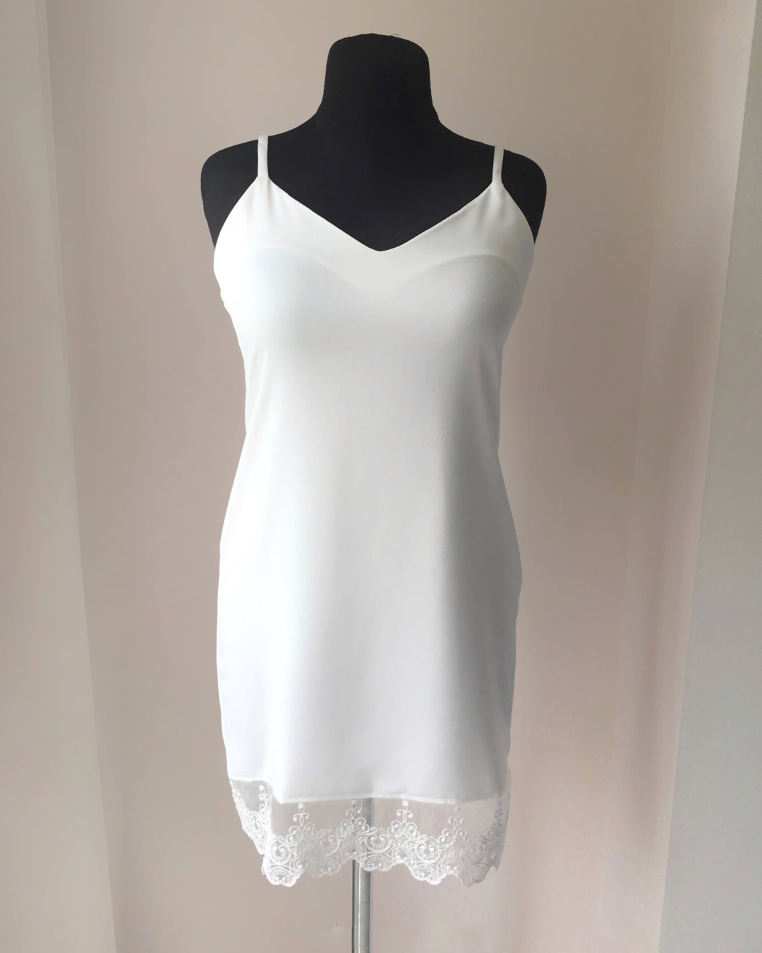 a woman's white tank top on a mannequin