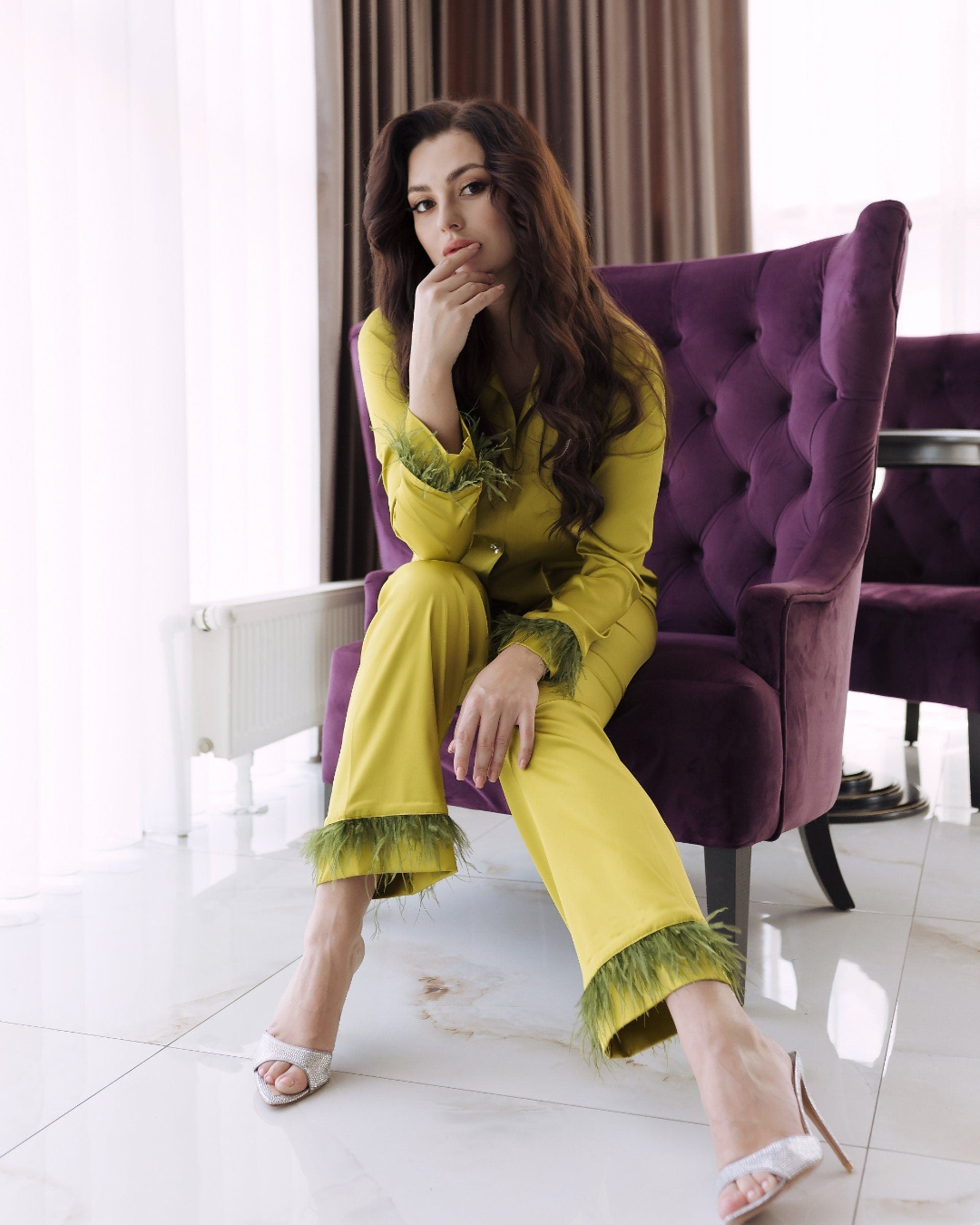 a woman sitting on a purple chair in a room