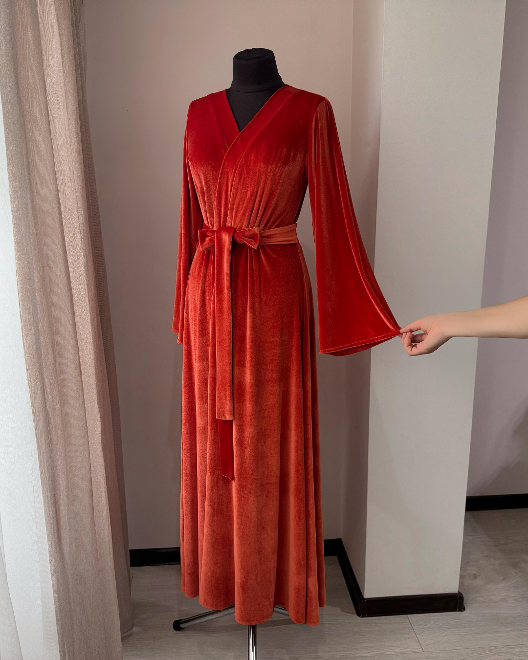 a woman's red robe on a mannequin