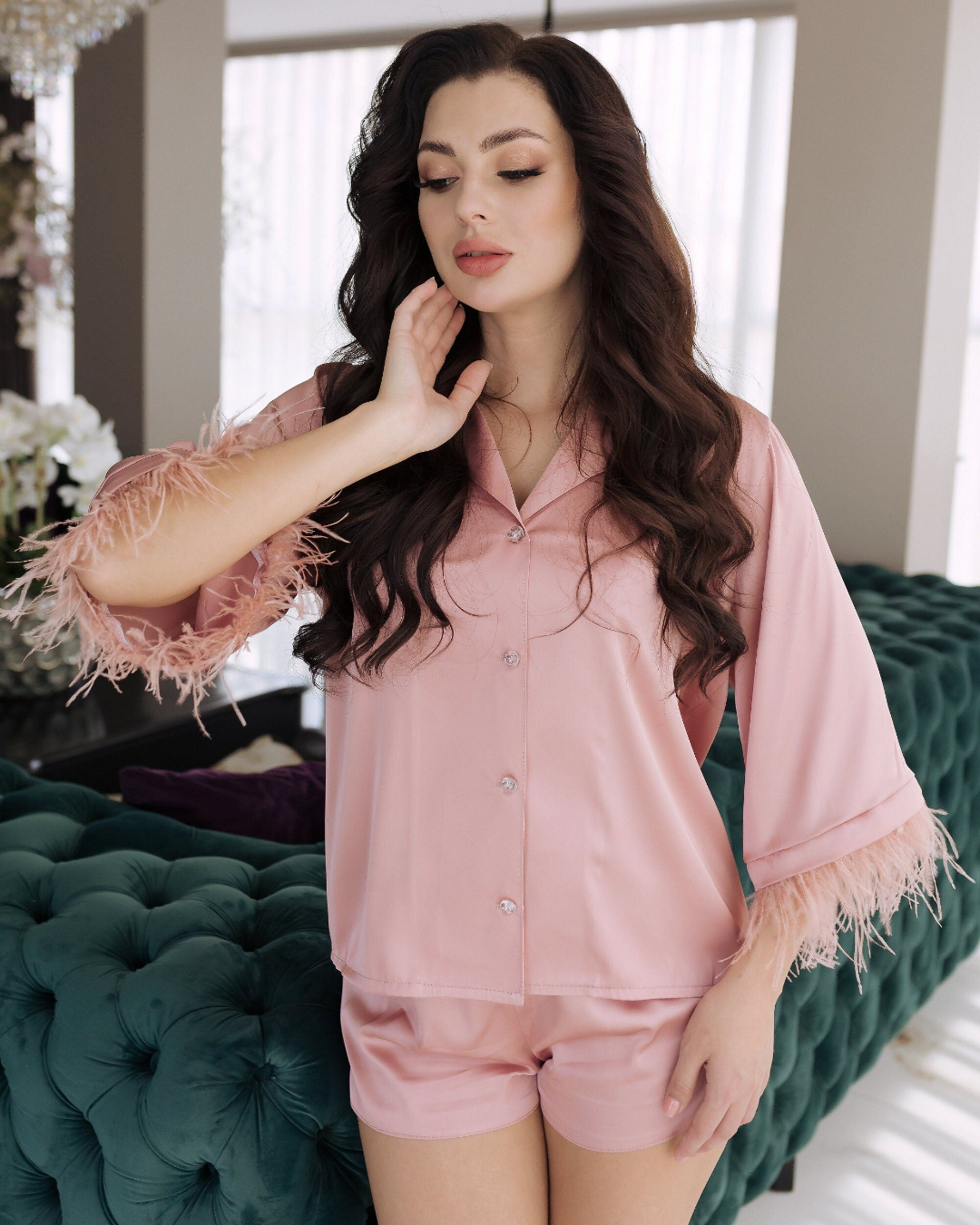 a woman in a pink shirt and shorts posing for a picture