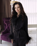 a woman standing in a room with a purple chair