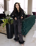 a woman standing in front of a green couch