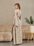 Side view of a long beige floral silk satin kimono robe
