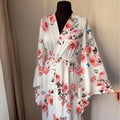 Ivory floral satin bridal robe with blush rose print and floor length wrap silhouette