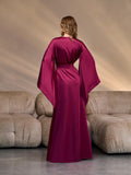 Back view of a long satin kimono robe in deep burgundy color with oversized draped sleeves and waist tie, showcasing the sleek silhouette and premium finish for bridal or lounge occasions.