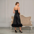 Back view of black satin midi slip dress with feather trim