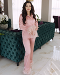 a woman in a pink outfit standing in front of a couch