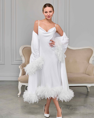 white feather-trimmed bridal robe layered over white satin nightgown with spaghetti straps, model posing elegantly