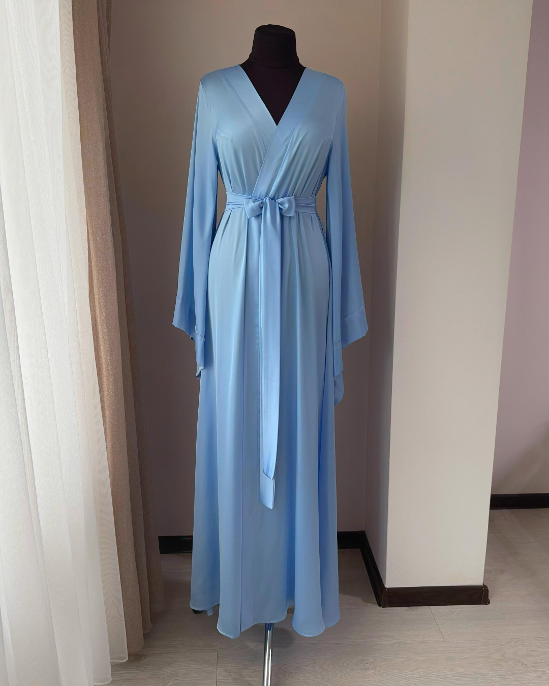 a woman's blue robe on a mannequin