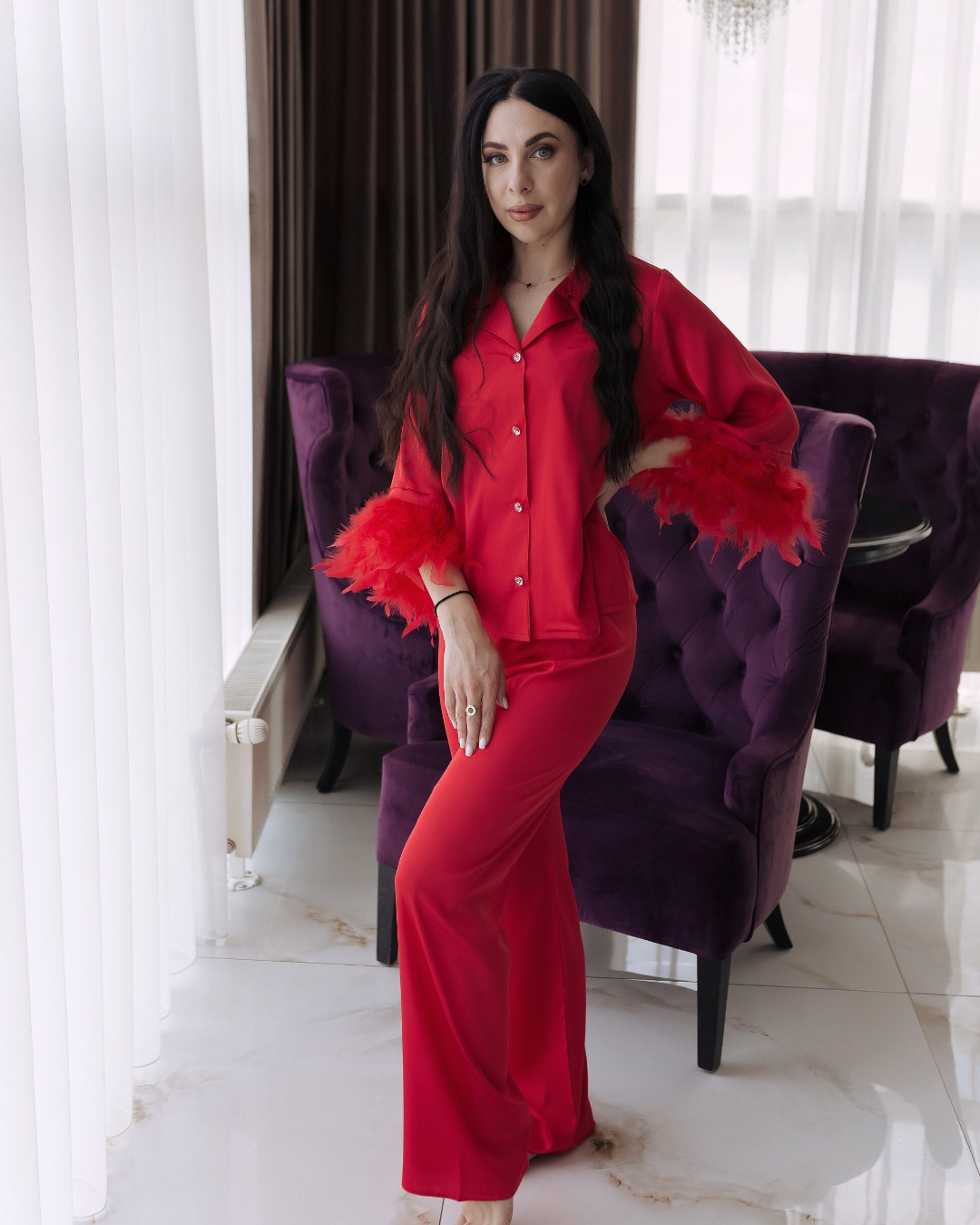 a woman in a red shirt and pants posing for a picture