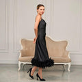 Side view of black feather midi dress with thin straps