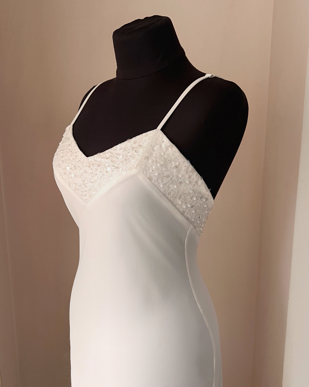 a white dress on a mannequin in a room