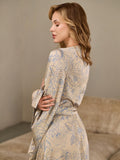 Close-up of the blue botanical line print on a beige satin kimono sleeve