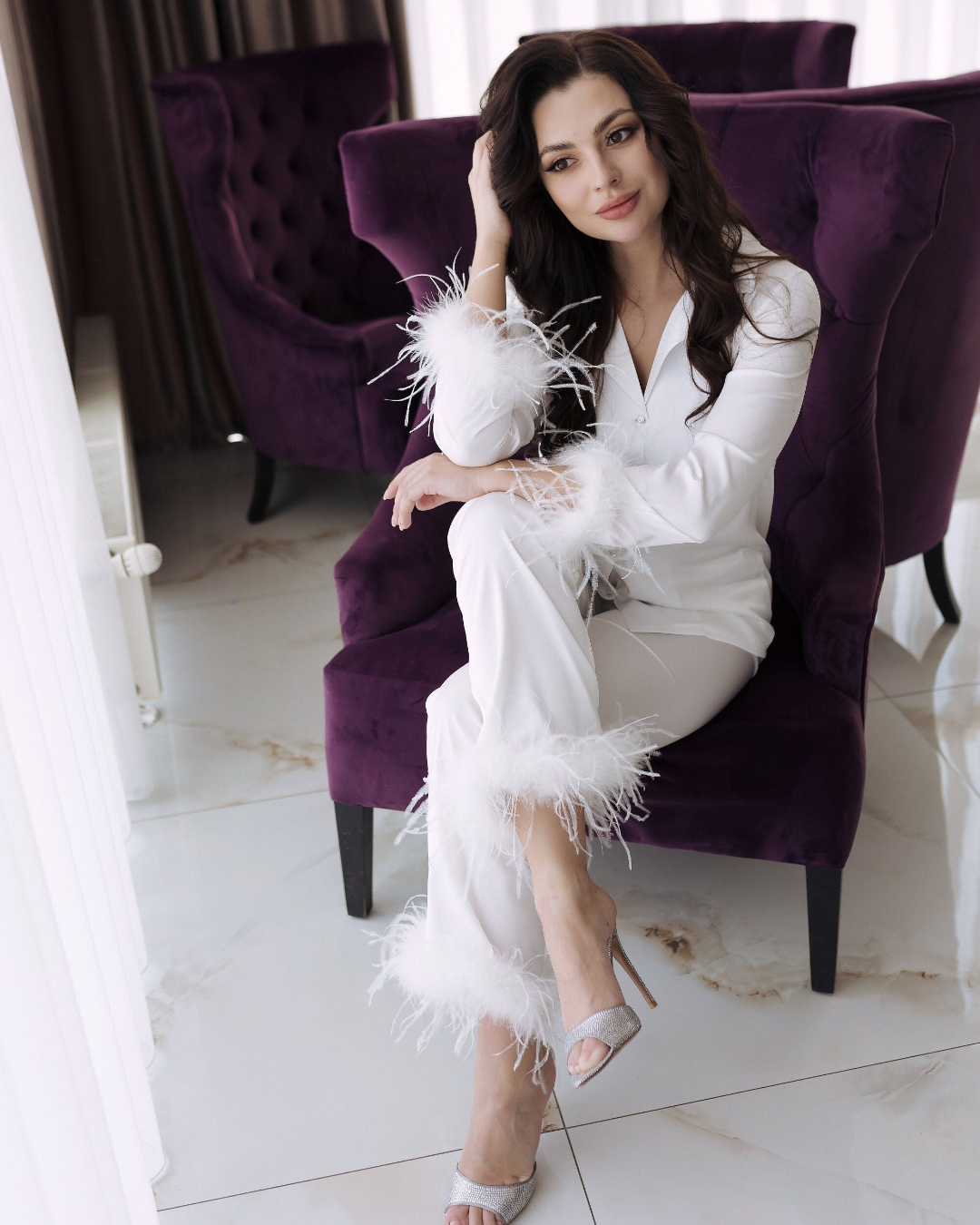 a woman sitting on a purple chair in a room