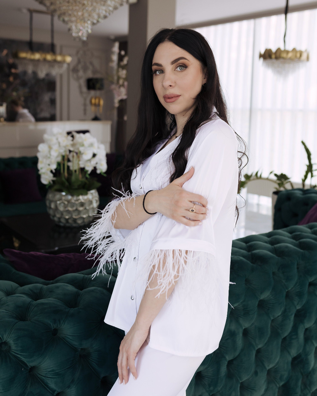 a woman standing in front of a green couch