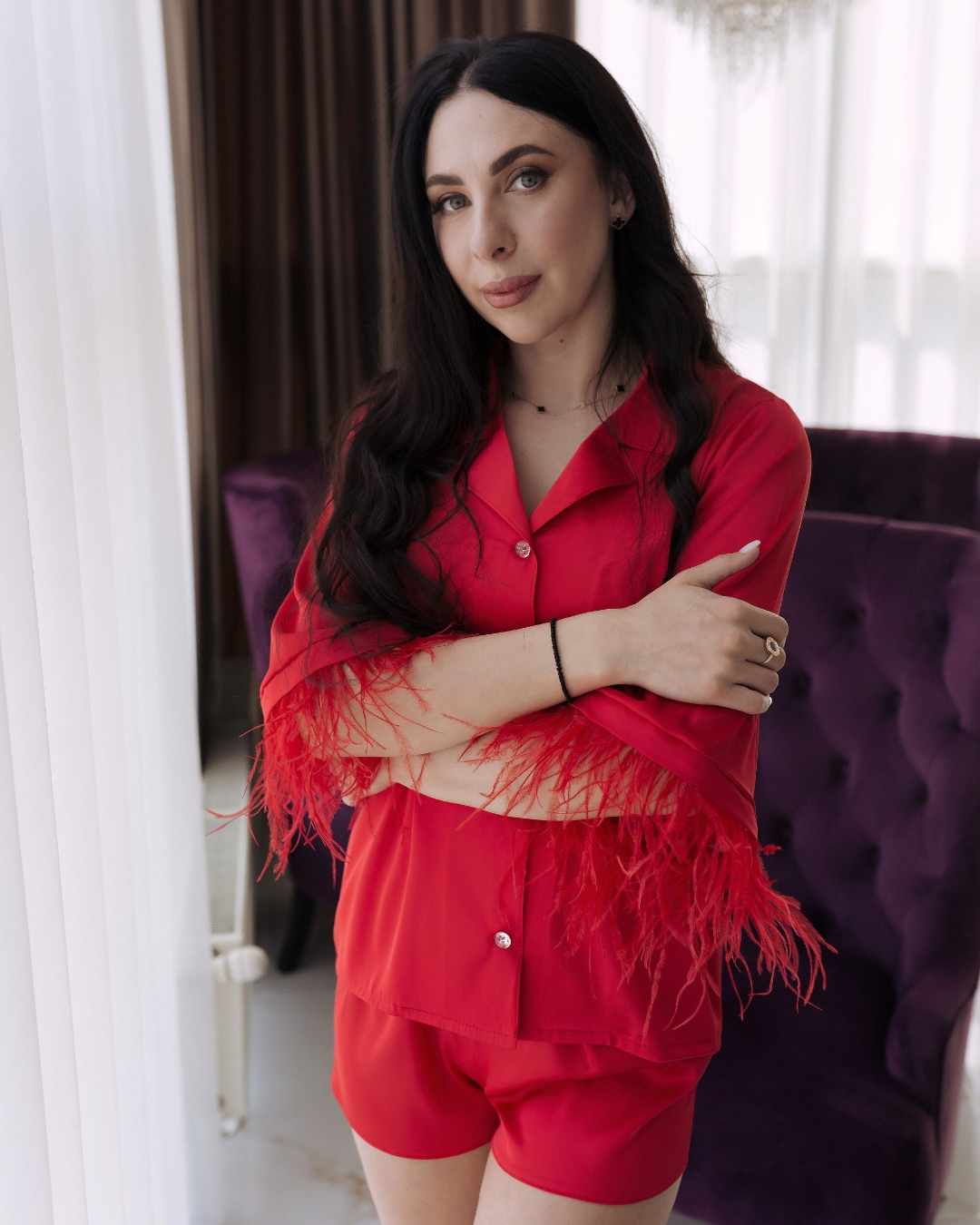 a woman in a red shirt and shorts posing for a picture