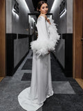 a woman in a white dress standing in a hallway