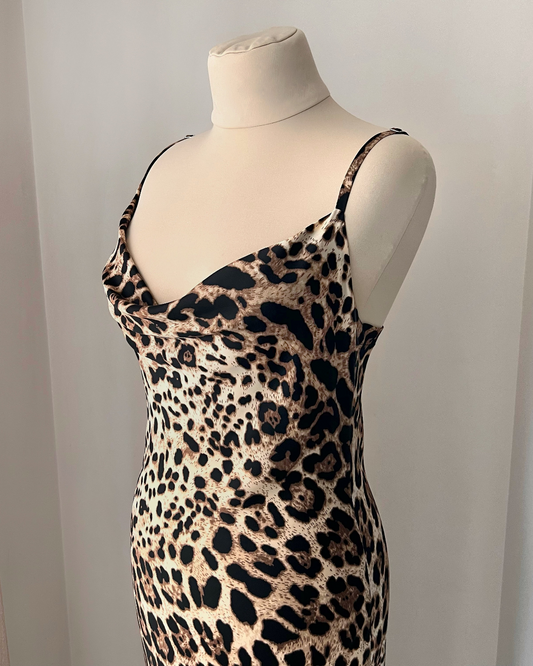 a mannequin wearing a leopard print dress