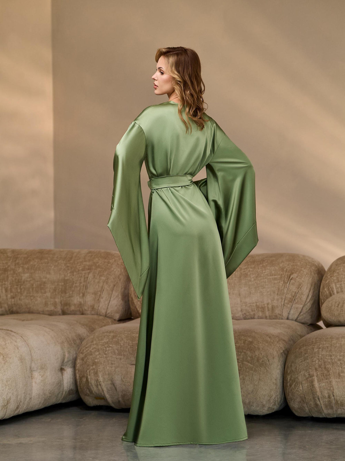 Back view of a long green silk kimono robe with belted waist
