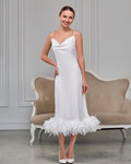 Front view of white feather slip dress with spaghetti straps and below-the-knee length