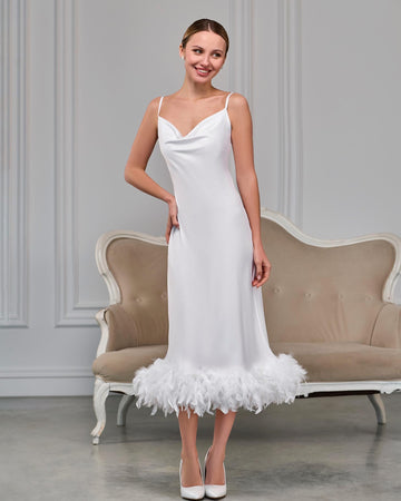 Front view of white feather slip dress with spaghetti straps and below-the-knee length