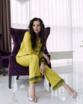 a woman in a yellow dress sitting on a purple chair