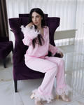 a woman in a pink outfit sitting on a purple chair