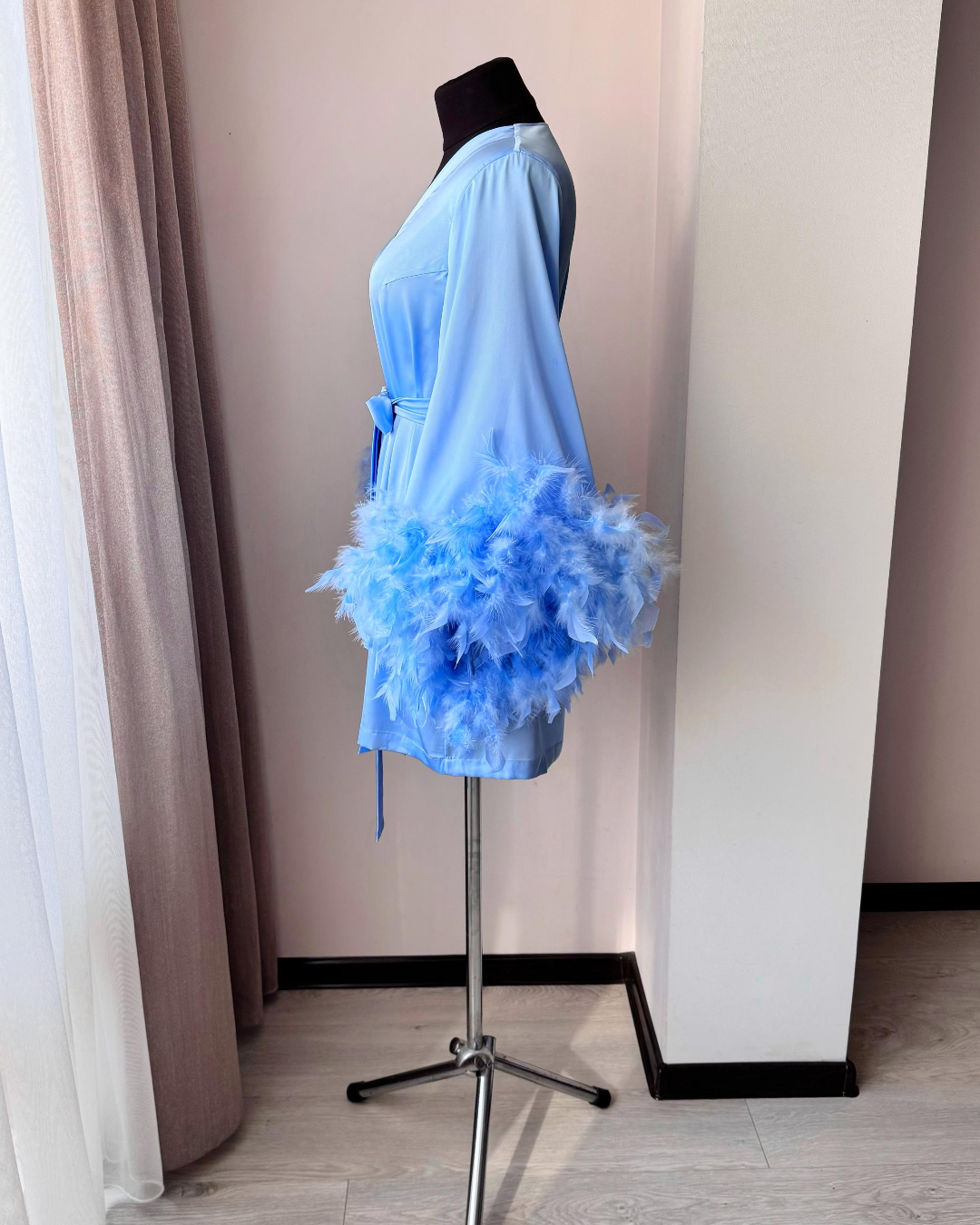 a mannequin with a blue dress on a stand