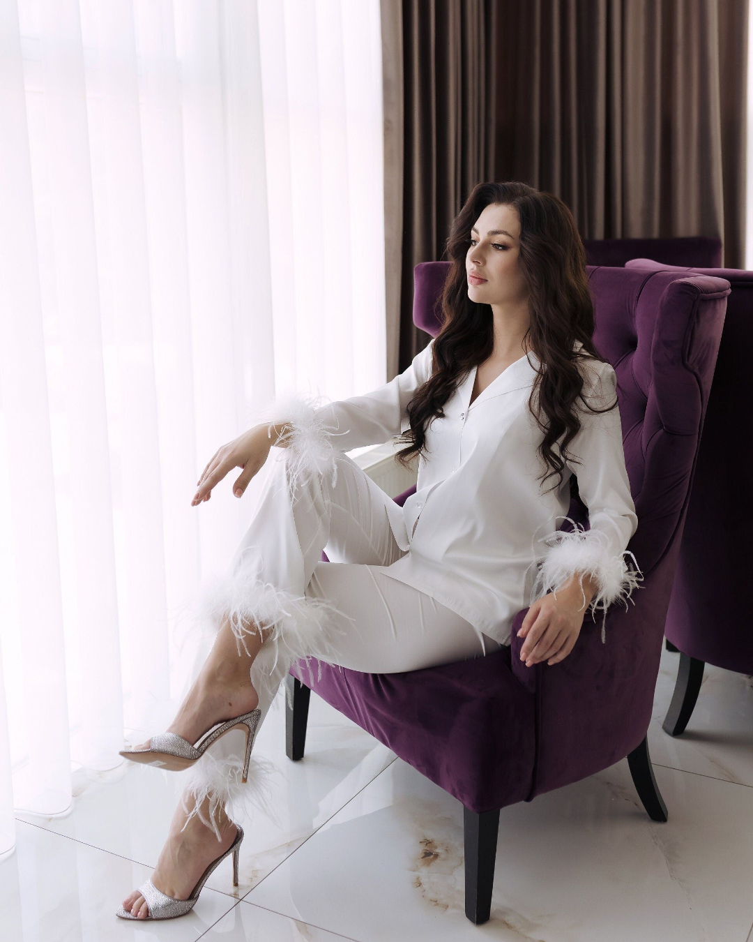 a woman sitting on a purple chair in a room