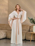 Bride in long ivory kimono robe with tie belt, front view