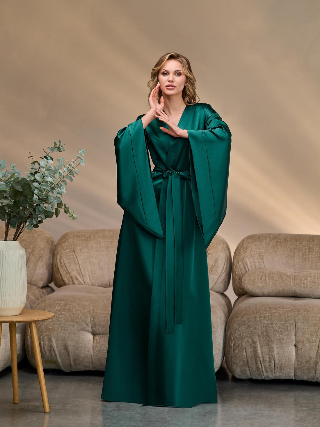 Long emerald satin kimono robe with wide sleeves and waist belt, elegant silhouette.