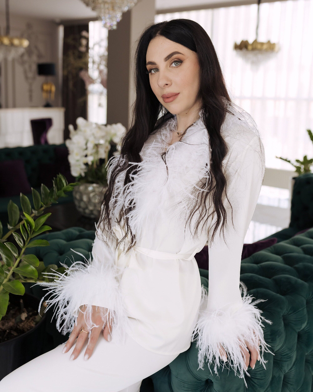 a woman sitting on a green couch in a room