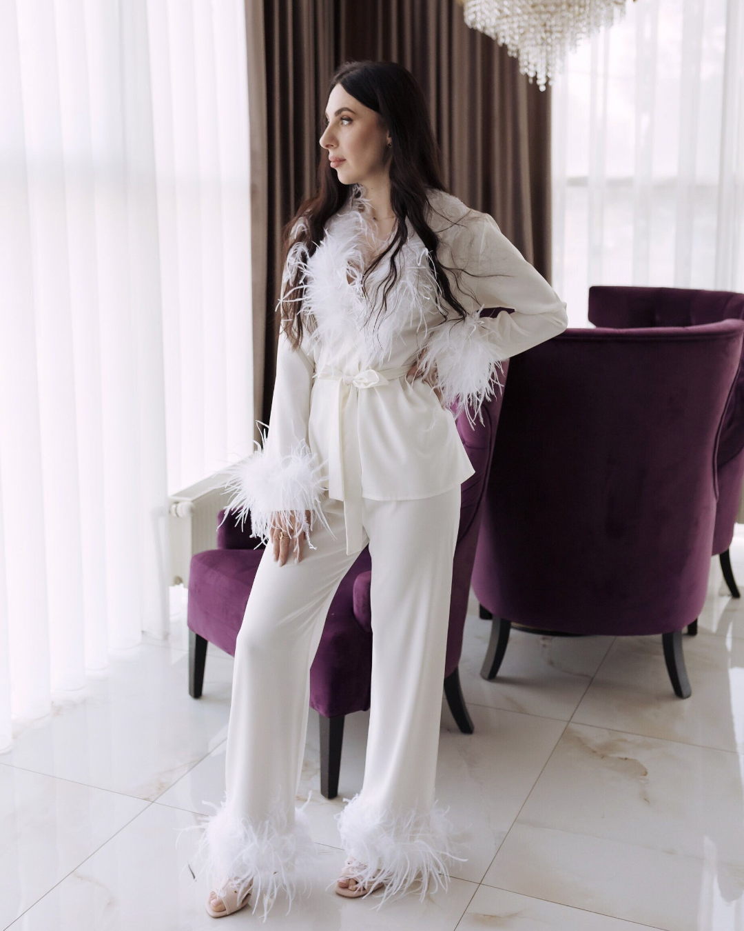 a woman standing in front of a purple chair