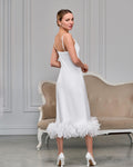 Back view of white satin bridal slip with adjustable spaghetti straps and feather hem
