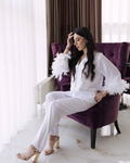 a woman sitting on a purple chair in a room