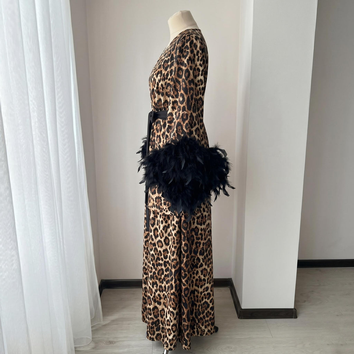 Long leopard satin robe with wide sleeves and statement black feather cuffs