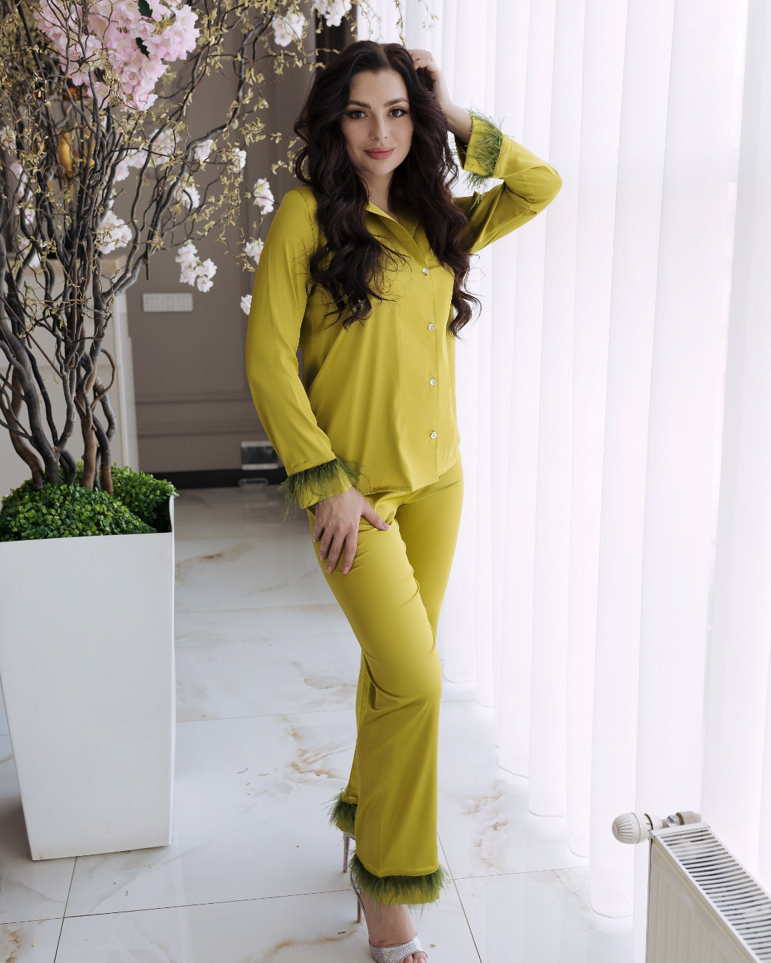 a woman in a yellow outfit posing for a picture