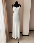 a white dress on a mannequin in a room