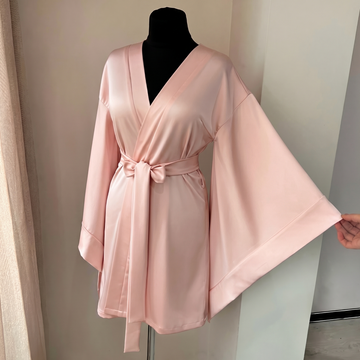 Short pink kimono robe for bridesmaids with soft fabric and a comfortable wrap silhouette.