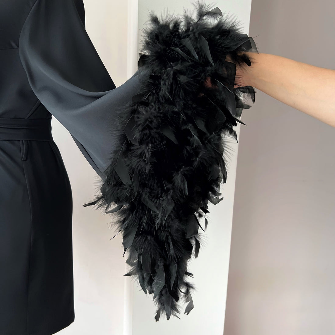 Short black satin feather robe with natural feather-trimmed three-quarter sleeves