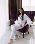 a woman sitting on a purple chair in a room