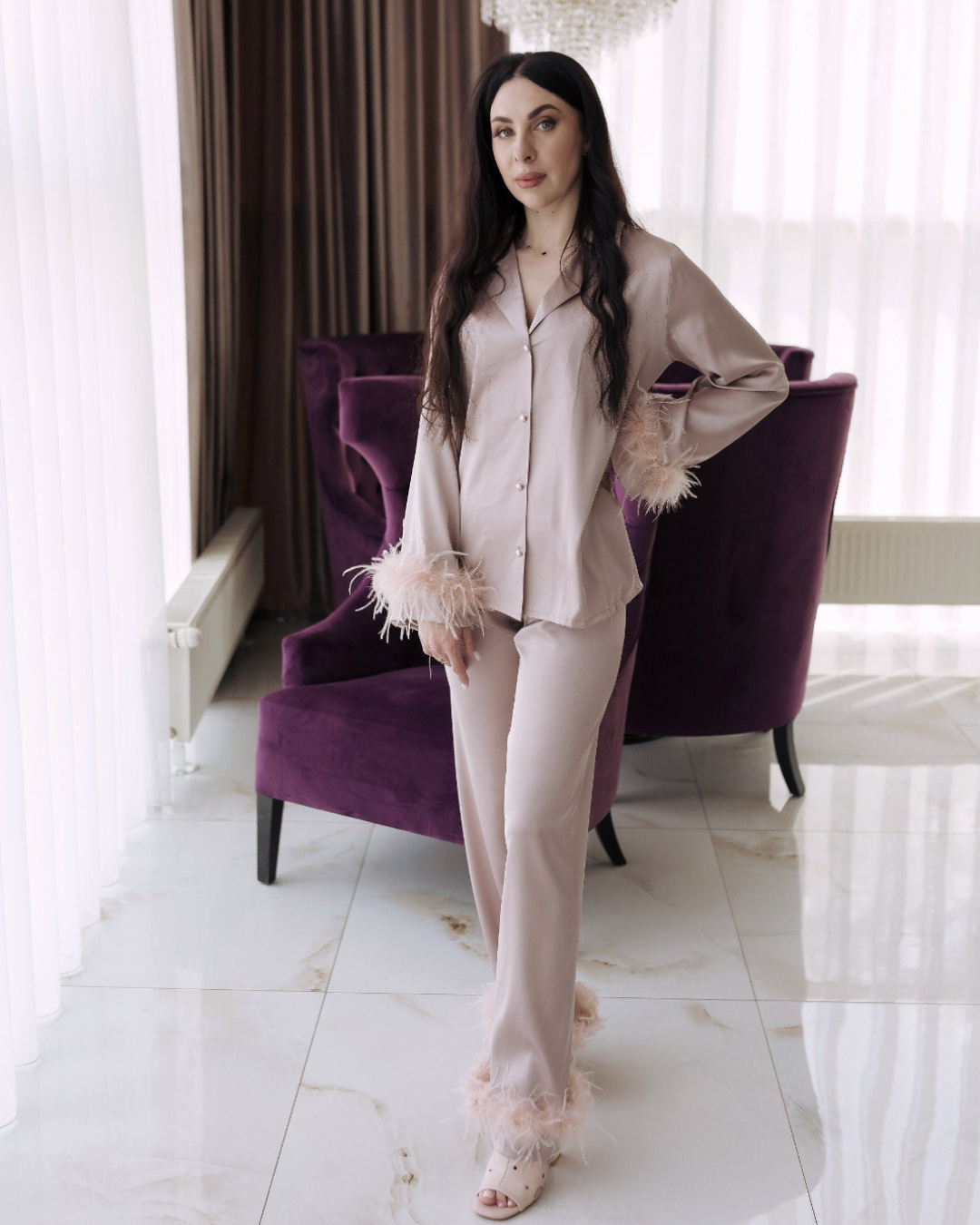 a woman standing in front of a purple chair