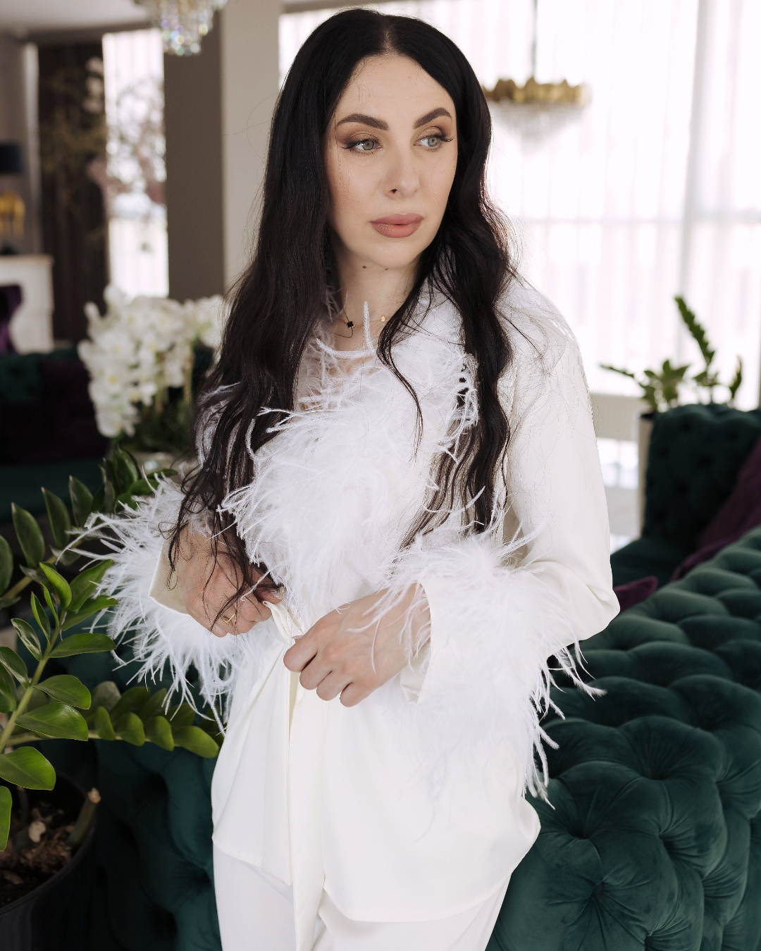 a woman in a white outfit posing for a picture